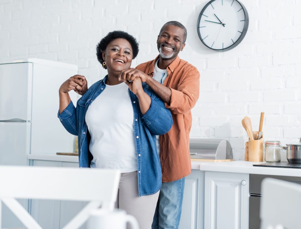 happy,senior,african,american,man,holding,hands,of,smiling,wife